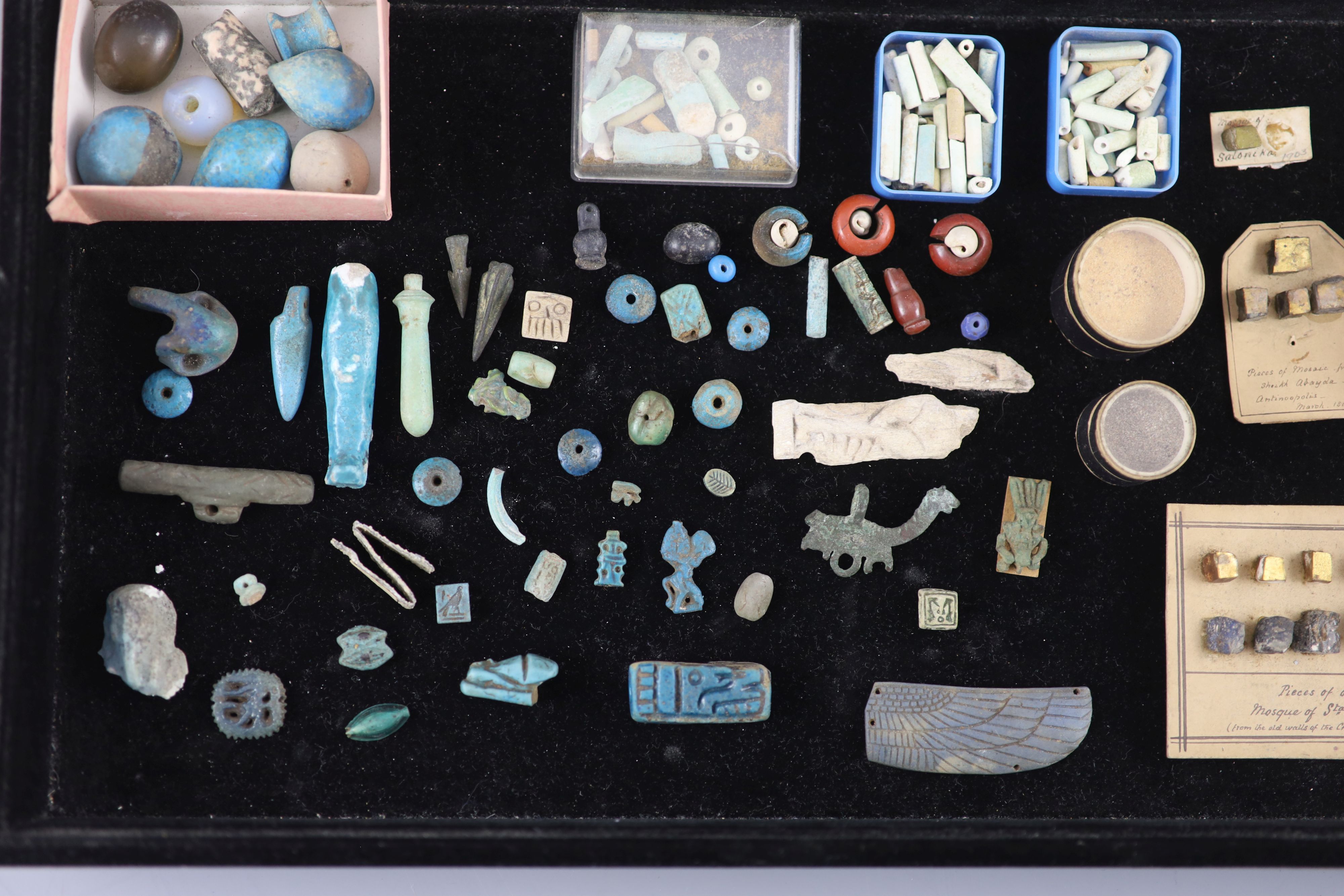 A group of Egyptian stone and turquoise glazed faience amulets, beads and fragments, late Kingdom to Roman period, Provenance - A. T. A